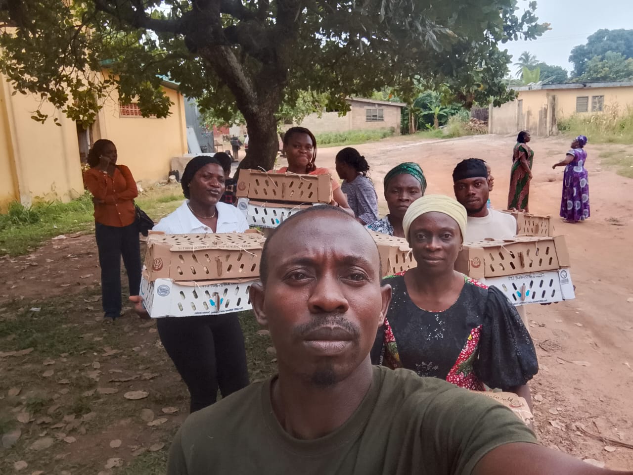 Farmers Union Nigeria community members holding poultry transport boxes